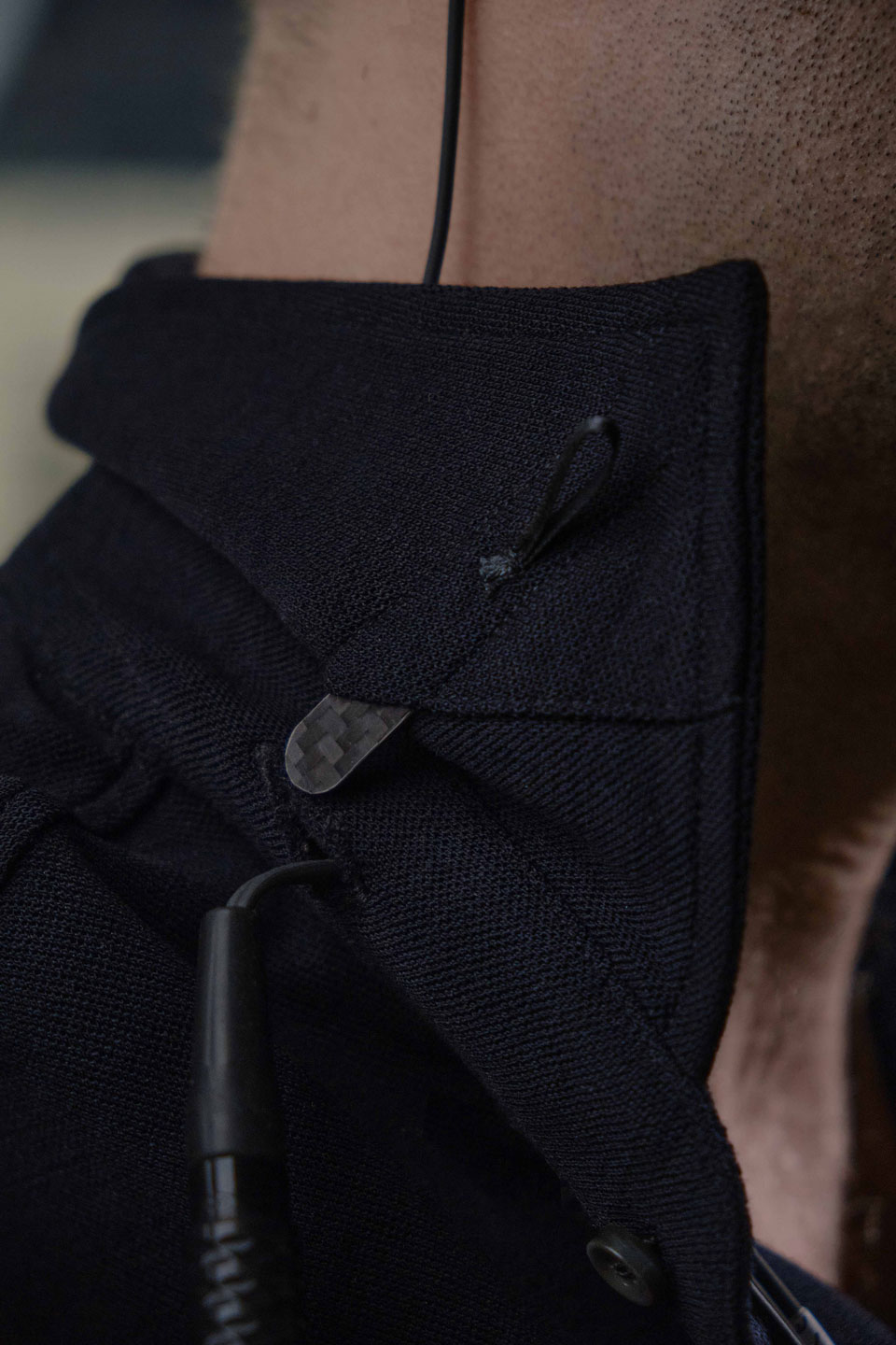 Close up of pique merino polo shirt collar with carbon fibre insert from Grayman and Company
