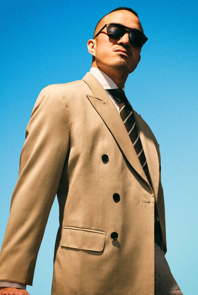 Asian man in double breasted suit with Grayman and Company Aviator ballistic sunglasses Bruce Lee homage