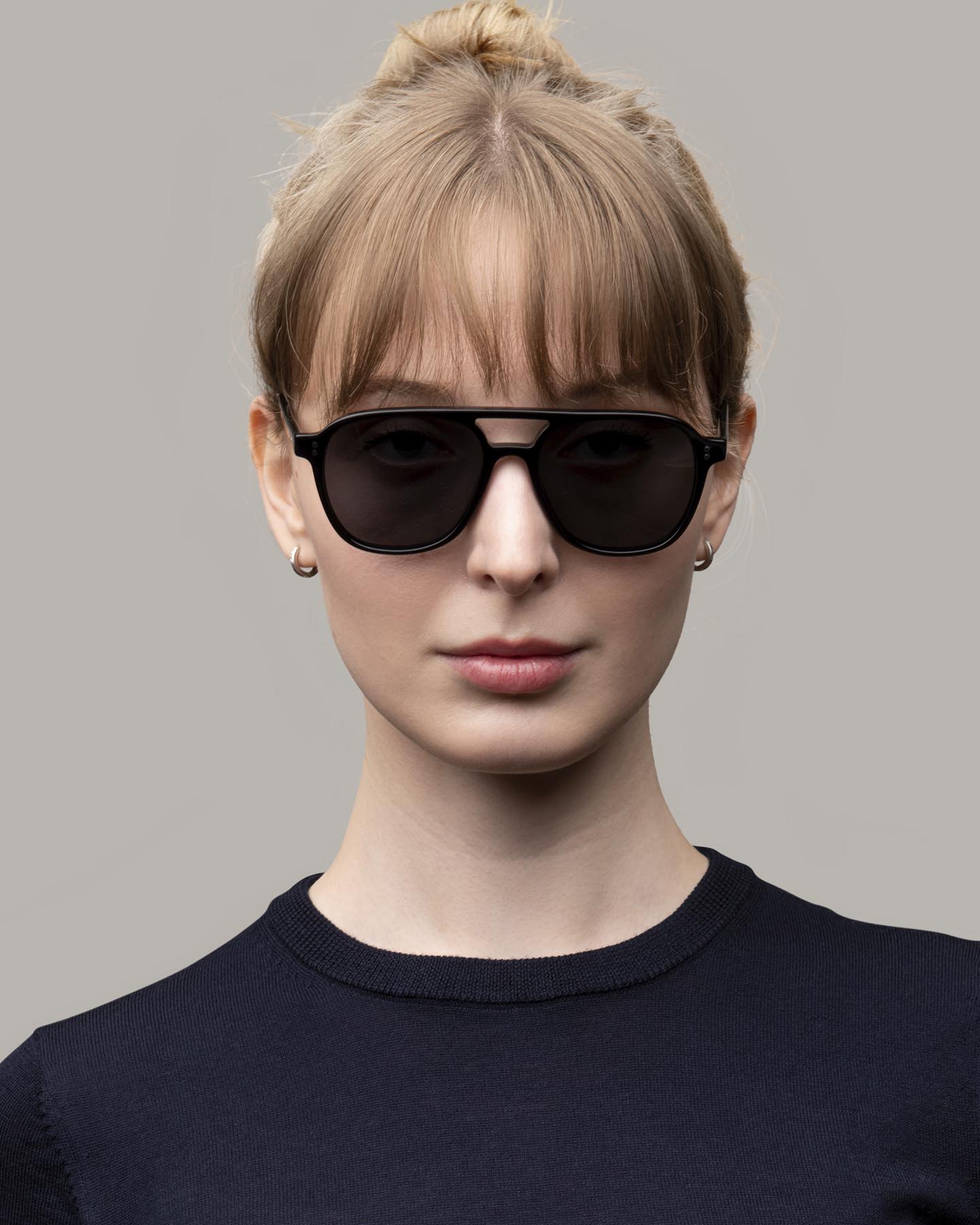 Headshot of woman in Grayman and Company 155a black ballistic aviator sunglasses