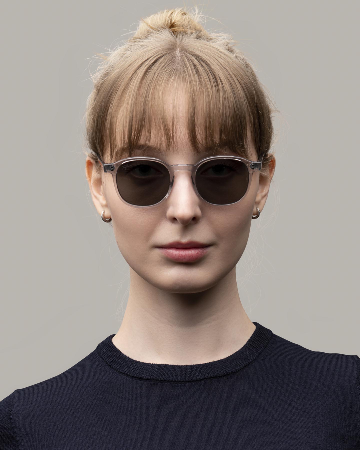 Headshot of woman in clear Grayman and Company KH12 wayfarer ballistic impact resistant sunglasses