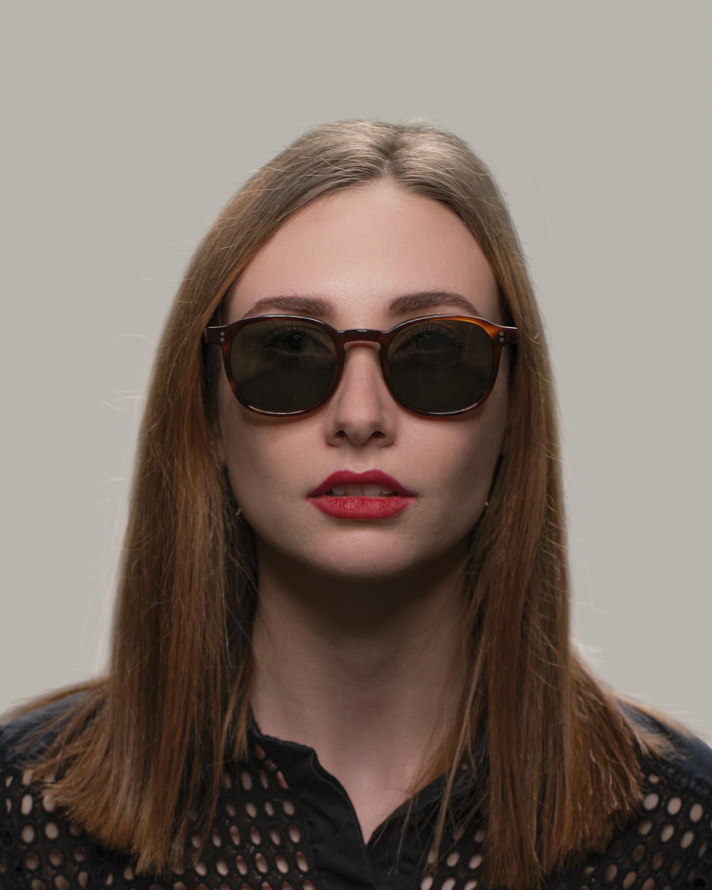 Headshot of woman in tortoise Grayman and Company KH12 wayfarer ballistic impact resistant sunglasses
